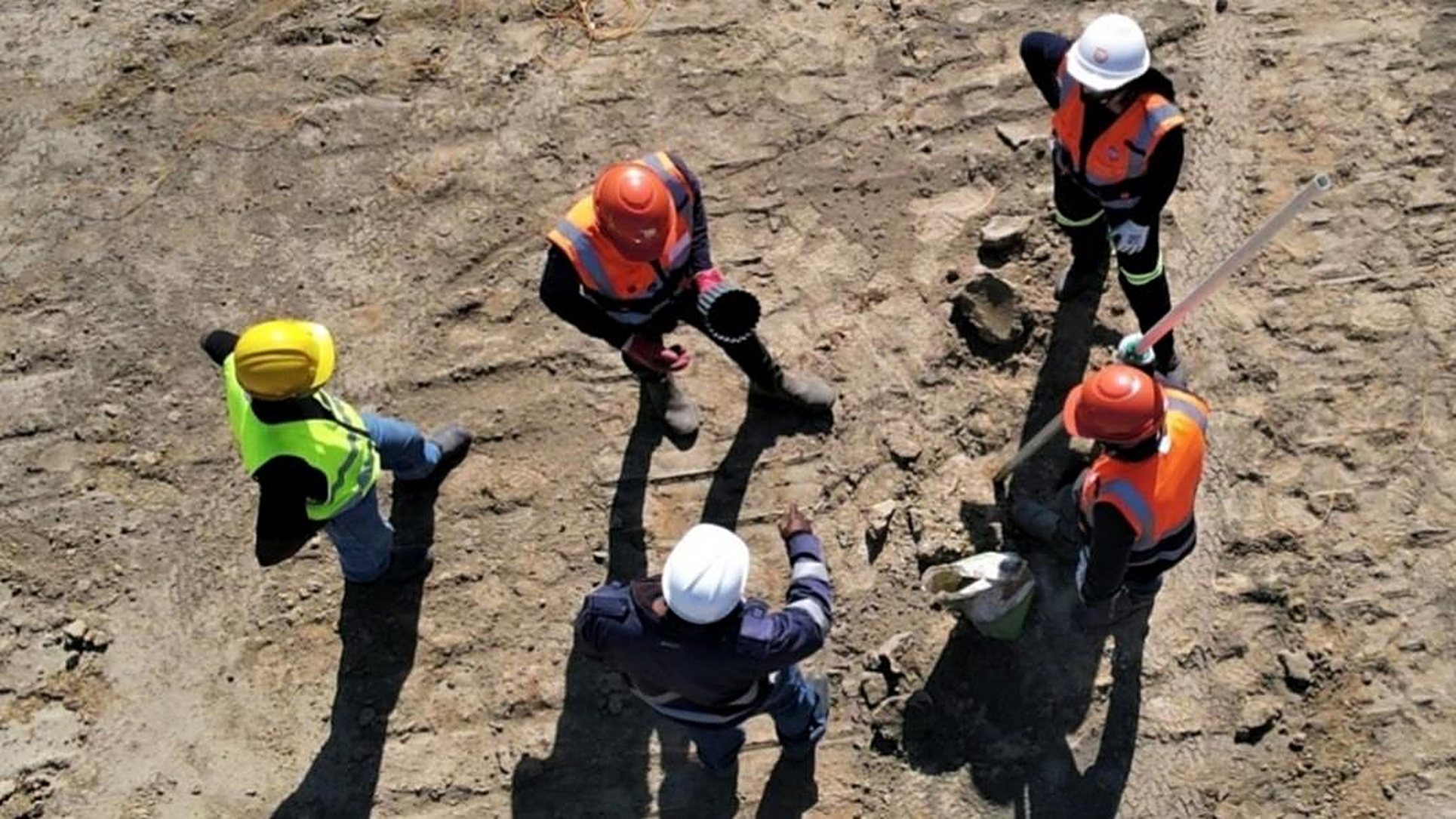 Aerial view of a site safety team in hard hats and hi-vis vests